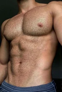 Shirtless guy showing off his chest and abs