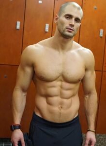 Shirtless guy showing off his chest and abs