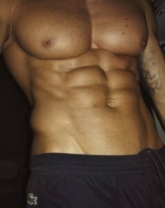 Shirtless guy showing off his chest and abs