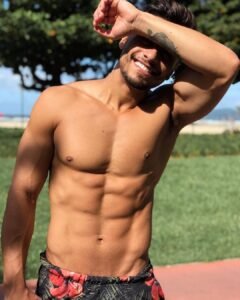 Shirtless guy showing off his chest and abs